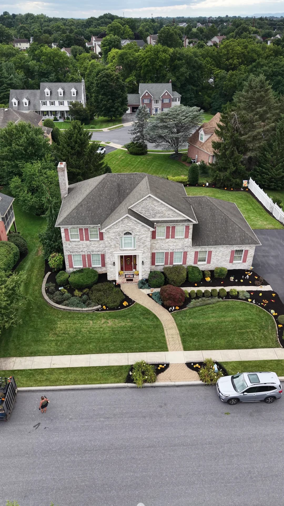Finished mulch beds and established plantings around the front of a home